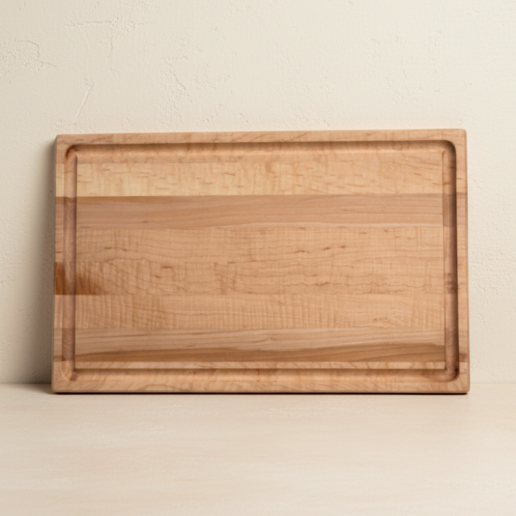 Wooden cutting board on a beige background
